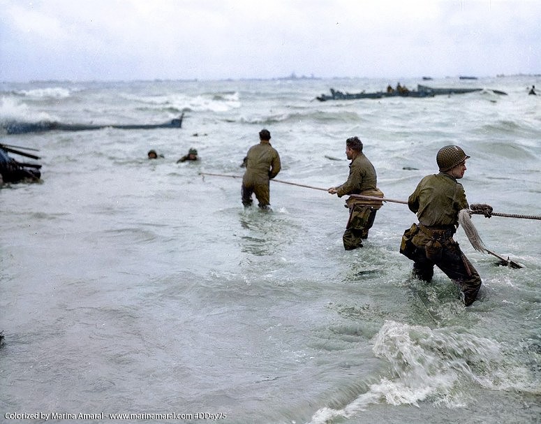5 U.S.-troops-use-a-lifeline-to-rescue-several-men-from-a-landing-craft-that-was-sunk-by-enemy-fire-on-D-Day-6-June-1944-1.jpg